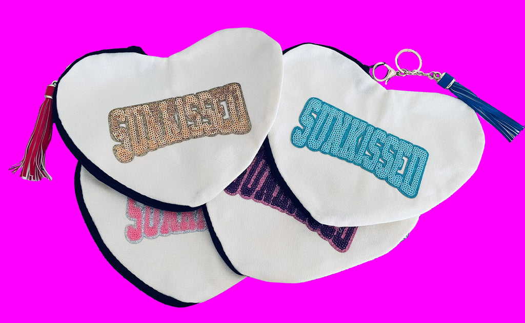 Sunkissed sequin heart-shaped canvas pouch with tassel accent