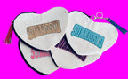 Sunkissed sequin heart-shaped canvas pouch with tassel accent