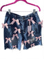 Distressed denim Bermuda shorts with pink bow accents ￼